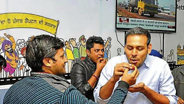 Co-founder of I-PAC Rishi Raj Singh being offered sweets at the Congress war room in Mohali on Saturday. The team that works for poll strategist Prashant Kishor has been tracking every development of the Punjab polls. (HT Photo) Co-founder of I-PAC Rishi Raj Singh being offered sweets at the Congress war room in Mohali on Saturday. The team that works for poll strategist Prashant Kishor has been tracking every development of the Punjab polls. (HT Photo)