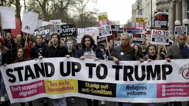 People hold a banner on Saturday as they take part in a protest march in London, against US President Donald Trump's ban on travellers and immigrants from seven predominantly Muslim countries entering the US. (AP) People hold a banner on Saturday as they take part in a protest march in London, against US President Donald Trump's ban on travellers and immigrants from seven predominantly Muslim countries entering the US. (AP)