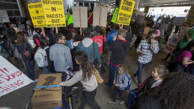 International travellers pass by people demonstrating in support of a ruling by a federal judge in Seattle that grants a nationwide temporary restraining order against the presidential order to ban travel to the United States from seven Muslim-majority countries, at Los Angeles International Airport. (AFP photo) International travellers pass by people demonstrating in support of a ruling by a federal judge in Seattle that grants a nationwide temporary restraining order against the presidential order to ban travel to the United States from seven Muslim-majority countries, at Los Angeles International Airport. (AFP photo)