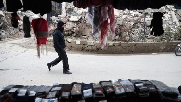A Syrian man walks past a shop in Douma. (Abd Doumany/AFP)