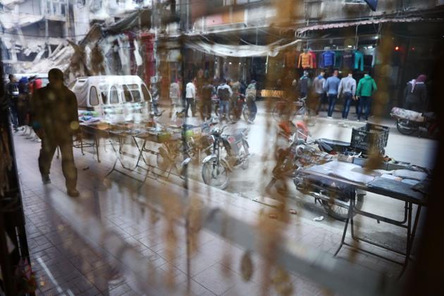 A picture taken from inside a shopfront shows a Syrian man walking in Douma. (Abd Doumany/AFP)
