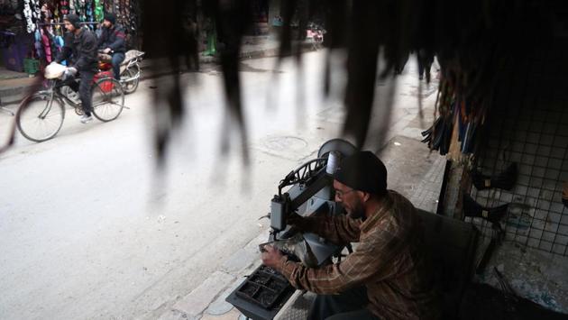 A Syrian cobbler works at his workshop in the rebel-held town of Douma. (Abd Doumany/AFP)
