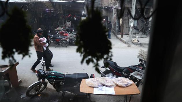 A Syrian family walks in a street . (Abd Doumany/AFP)