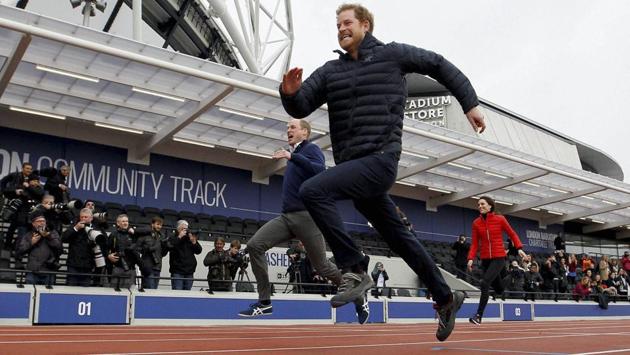 Prince Harry dashes past Prince William and Kate, the Duchess of Cambridge in a relay race during the promotion of the charity Heads Together at the Queen Elizabeth II Park in London. (AP)