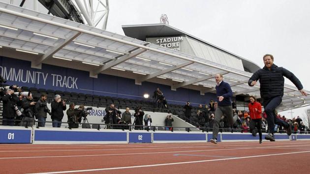 Prince Harry dashes past Prince William and Kate, the Duchess of Cambridge in a relay race during the promotion of the charity Heads Together at the Queen Elizabeth II Park in London. (AP)