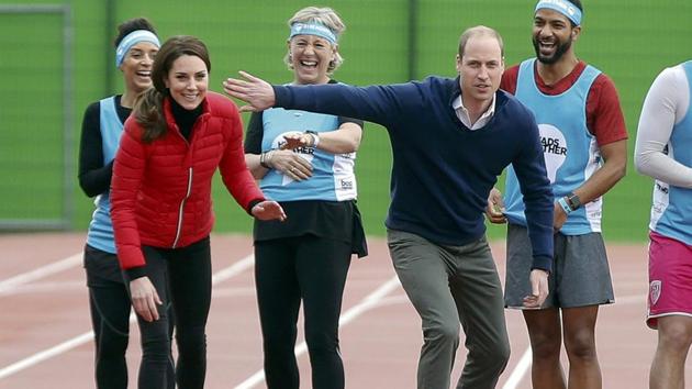 Prince William holds up his arm in an attempt to block his wife Kate, the Duchess of Cambridge, as they line up for a relay race during the promotion of the charity Heads Together at the Queen Elizabeth II Park in London. (REUTERS)