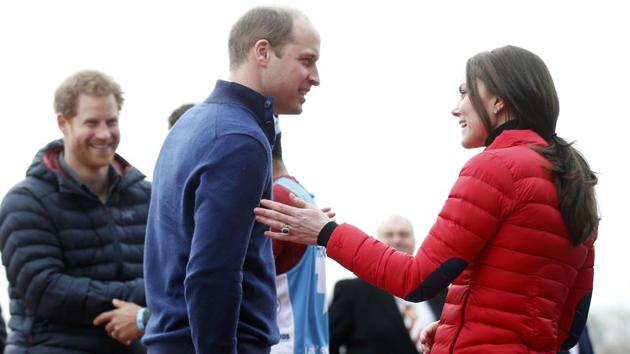 Prince William (middle), his wife Kate, the Duchess of Cambridge, and Prince Harry (left) react after taking part in a relay race during the promotion of the charity Heads Together at the Queen Elizabeth II Park in London. (REUTERS)