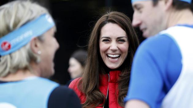 Kate, the Duchess of Cambridge, laughs as she prepares to take part in a relay race during the promotion of a charity Heads Together at the Queen Elizabeth II Park in London. (REUTERS)
