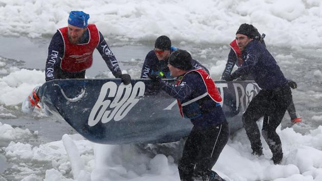 Team PMT Roy competes in the ice canoe race at the Quebec Winter Carnival in Quebec City. (REUTERS)