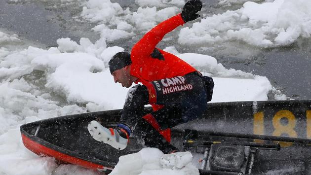 A canoer jumps over a block of ice during the ice canoe race at the Quebec Winter Carnival in Quebec City. (REUTERS)