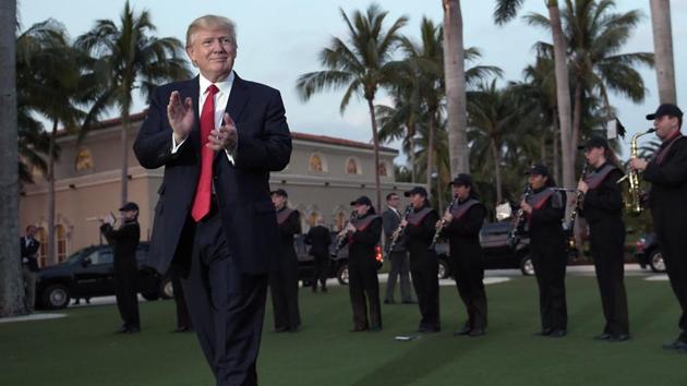 US President Donald Trump listens to the Palm Beach Central High School Band as they play at his arrival at Trump International Golf Club in West Palm Beach. (AP photo) US President Donald Trump listens to the Palm Beach Central High School Band as they play at his arrival at Trump International Golf Club in West Palm Beach. (AP photo)