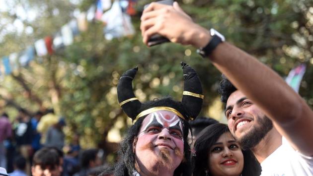 People takes selfies with a man dressed as Yamraj, god of death. (Pratik Chorge/HT )
