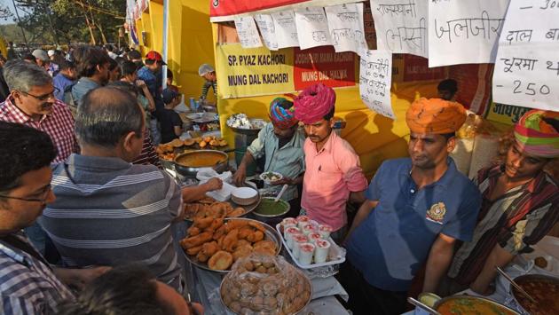 Hungry patrons dig into Rajasthani food at one of the many stalls dotting the landscape at the HT Kala Ghoda Arts Festival at Cross Maidan on Sunday. (Pratik Chorge/HT )