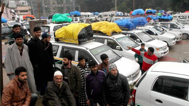 Kashmir-bound passengers on the outskirts of Jammu on Sunday. Heavy rainfall and landslides led to the blockade of Jammu-Srinagar National Highway for the third consecutive day. (PTI Photo) Kashmir-bound passengers on the outskirts of Jammu on Sunday. Heavy rainfall and landslides led to the blockade of Jammu-Srinagar National Highway for the third consecutive day. (PTI Photo)