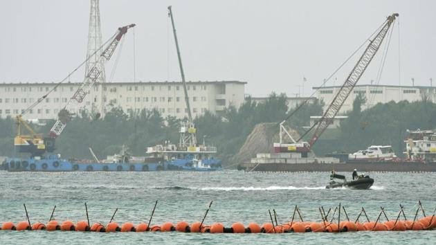 A boat goes by cranes being used for the preparation work to relocate a US Marine base to Henoko to dump large concrete blocks into sea along the shore in Nago, Okinawa Prefecture, southern Japan. Japan's government has started offshore construction work on relocating a US Marine base on Okinawa. (AP Photo) A boat goes by cranes being used for the preparation work to relocate a US Marine base to Henoko to dump large concrete blocks into sea along the shore in Nago, Okinawa Prefecture, southern Japan. Japan's government has started offshore construction work on relocating a US Marine base on Okinawa. (AP Photo)
