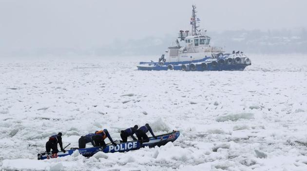 Team Police de Quebec compete in the ice canoe race at the Quebec Winter Carnival in Quebec City. (REUTERS)