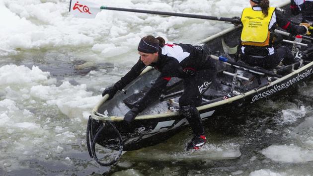 Team Financiere Banque Nationale takes part in the ice canoe race on the Saint Lawrence river as part of the Quebec Winter Carnival in Quebec. (AP)