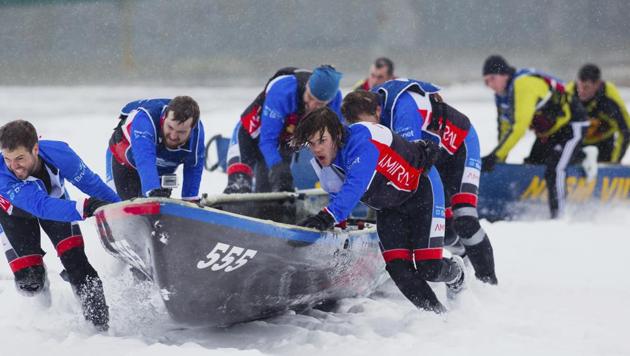 Team Amiral/Pharmacie Marie-Pier Labbe Inc. takes part in the ice canoe race on the Saint Lawrence river as part of the Quebec Winter Carnival in Quebec on Sunday. (AP)