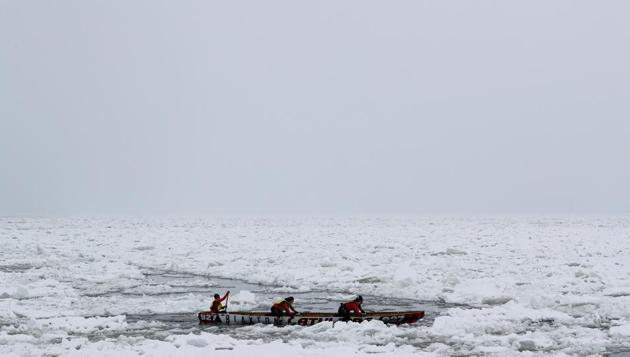 Team Latulipe competes in the ice canoe race at the Quebec Winter Carnival in Quebec City. (REUTERS)