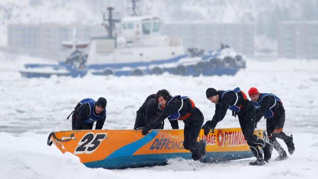 Team Optimum competes in the ice canoe race at the Quebec Winter Carnival in Quebec City. (REUTERS)