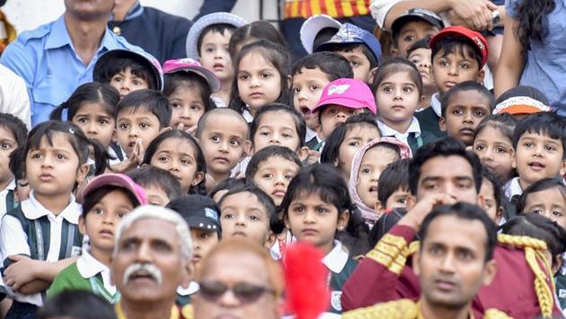 Schoolchildren watch as the firemen perform the Angus Ladder drill. (Kunal Patil/Ht photo)
