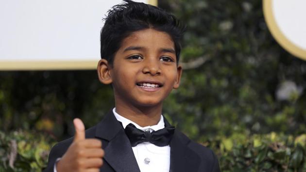 His big smile + thumbs up + one very dapper tux = winning every single heart. (REUTERS)