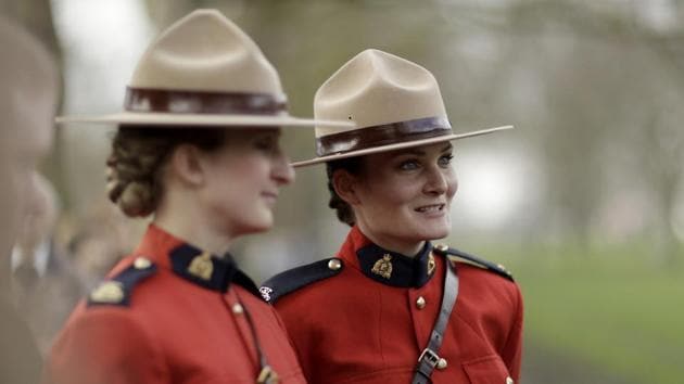 Members of the Royal Canadian Mounted Police Musical Ride, from Ottawa, Canada, speak to people after watching the King's Troop Royal Horse Artillery stage a 41-Gun Royal Salute to celebrate Britain's Queen Elizabeth II's Sapphire Jubilee. (Matt Dunham / AP)