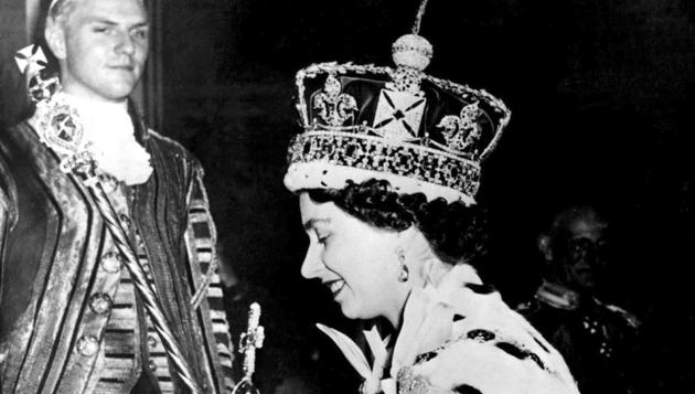 In this June 2, 1953 file photo, Britain's Queen Elizabeth II wearing the bejeweled Imperial Crown and carrying the Orb and Scepter with Cross, leaves Westminster Abbey, London, at the end of her coronation ceremony. (AP Photo/File)