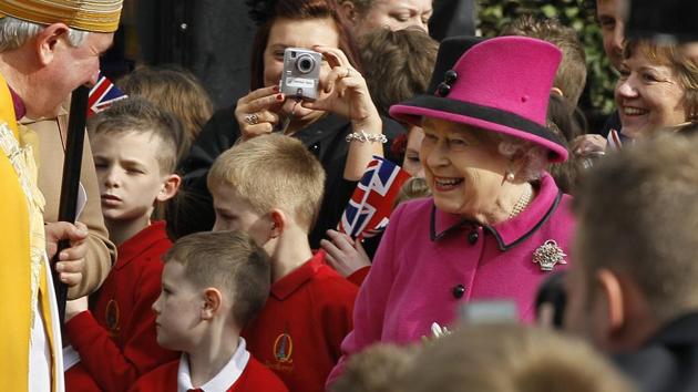 FILE - In this Thursday, March 8, 2012 file photo, Britain's Queen Elizabeth II escorted by The Bishop of Leicester, left, meets members of the public during a walkabout at Leicester Cathedral in Leicester, England. (Kirsty Wigglesworth / AP)