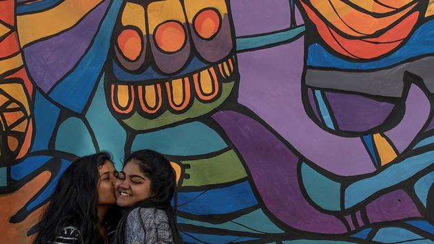 A colourful installation offers a perfect background to these youngsters.  (Satish Bate/HT PHOTO) 
