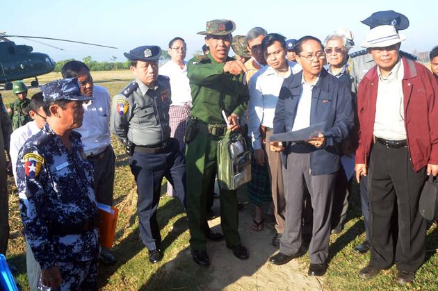 A military official briefs Myanmar vice-president Myint Swe (in blue jacket) during his visit to Gwazon, a Muslim majority village in Rakhine state near the Bangladesh border. (AFP File) A military official briefs Myanmar vice-president Myint Swe (in blue jacket) during his visit to Gwazon, a Muslim majority village in Rakhine state near the Bangladesh border. (AFP File)