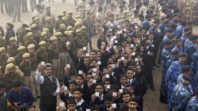 Students hold up badges urging people to cast their votes, during an election awareness campaign in Uttar Pradesh. Elections in northern Uttar Pradesh begin on February 11.(AP)
