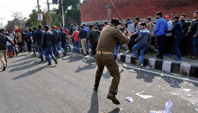 A policeman disperses protesters during a rally in Jammu.(PTI/ Representative photo)