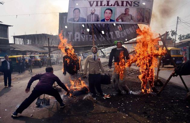 Protesters burn effigies of Nagaland CM TR Zeliang and other ministers during a protest in Dimapur on Tuesday against the killing of two youth last month. (PTI) Protesters burn effigies of Nagaland CM TR Zeliang and other ministers during a protest in Dimapur on Tuesday against the killing of two youth last month. (PTI)