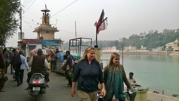 Foreigners pass by a political rally in Rishikesh.(Neha Pant/HT)