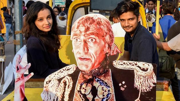 Two youngsters are happy posing with a cutout of this iconic film character. (Kunal Patil/Hindustan Times) 