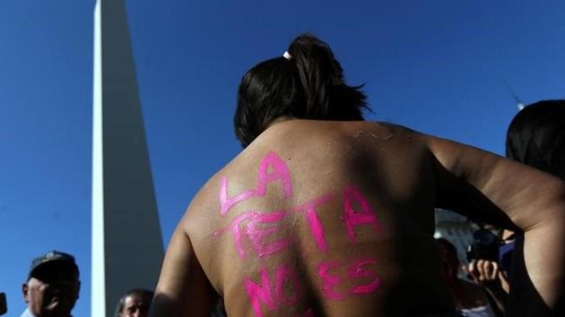 A woman poses topless with the words "The tit is not a crime" written on her back during a protest in response to a recent incident on an Argentine resort beach between police and topless sunbathers, in downtown Buenos Aires in Argentina.(Reuters Photo)