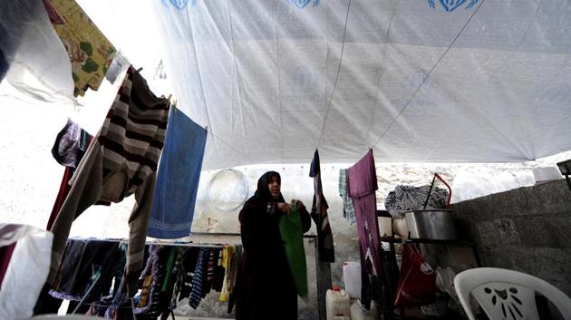 Heyam Batash, 56, hangs clothes at her house in al-Mouassassi street in Aleppo, Syria, January 30.(REUTERS)