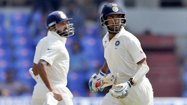 India's Cheteshwar Pujara, right, and Murali Vijay run between the wickets. (AP)