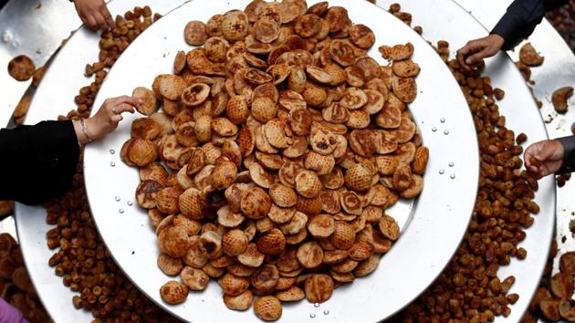 People have a traditional cookie, known as Kleicha. (Faisal Al Nasser / REUTERS)