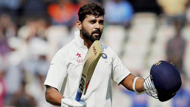 Murali Vijay raises his bat and helmet to celebrate scoring a century against Bangladesh. (PTI)