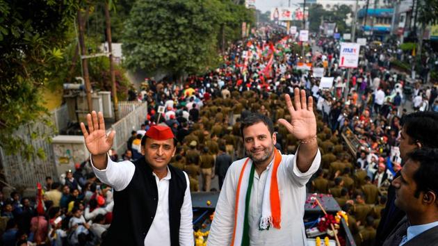 Congress party vice president Rahul Gandhi (R) and Uttar Pradesh chief minister Akhilesh Yadav (L) wave during a joint election rally in Agra . Elections in northern Uttar Pradesh begin on February 11, and voting is divided into seven phases. (CHANDAN KHANNA / AFP)