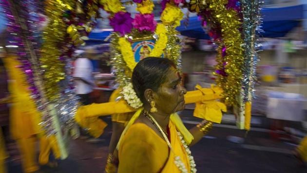 A woman carries her Kavadi during a procession of the Thaipusam at Batu Caves in Kuala Lumpur. For many, the festival is an opportunity to seek blessings, observe penance and offer thanks for fulfilling prayers. (Daniel Chan / AP) A woman carries her Kavadi during a procession of the Thaipusam at Batu Caves in Kuala Lumpur. For many, the festival is an opportunity to seek blessings, observe penance and offer thanks for fulfilling prayers. (Daniel Chan / AP)