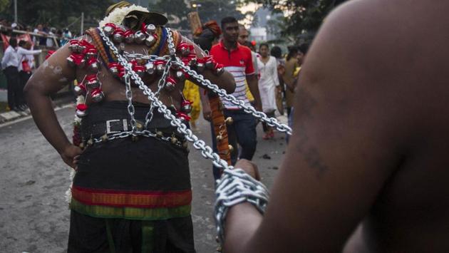 A Hindu devotee with hooks and chains dug into his back takes part in the Thaipusam festival in Kuala Lumpur. (Daniel Chan / AP) A Hindu devotee with hooks and chains dug into his back takes part in the Thaipusam festival in Kuala Lumpur. (Daniel Chan / AP)