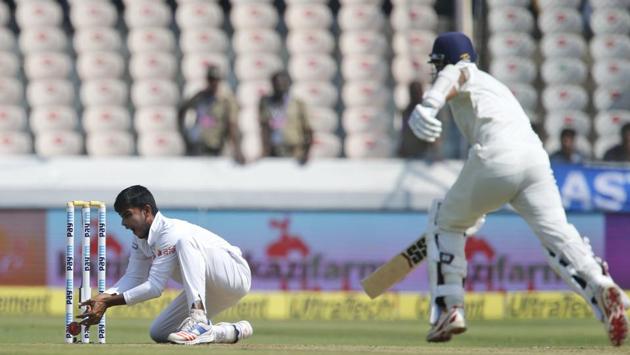 Bangladesh's Mehedi Hasan, left, attempts an unsuccessful run-out of India's Murali Vijay, right, during their first day of the test match in Hyderabad. (AP)