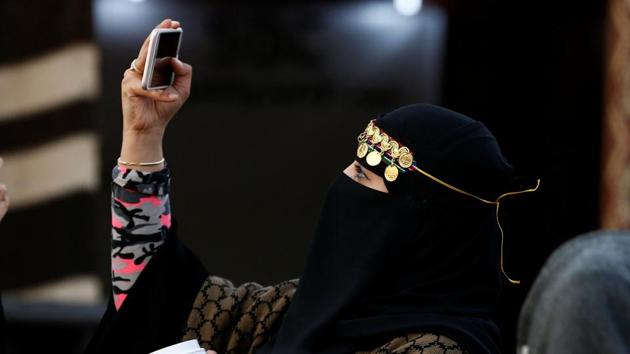A woman takes a selfie at the selfie. (Faisal Al Nasser / REUTERS)