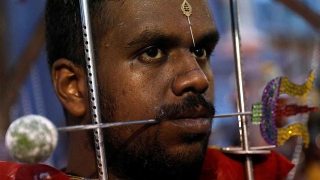 A devotee with a trident pierced through his mouth carries a kavadi as a part of the Thaipusam procession in Singapore. (Edgar Su / REUTERS) A devotee with a trident pierced through his mouth carries a kavadi as a part of the Thaipusam procession in Singapore. (Edgar Su / REUTERS)