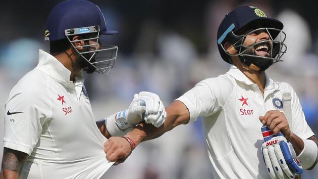 India cricket team captain Virat Kohli (right) and Murali Vijay share a light moment during Day 1 of the Test against Bangladesh Cricket team in Hyderabad on Thursday.(AP)