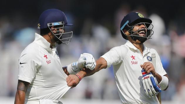 Centurions Murali Vijay (left) and Virat Kohli share a light moment on Day 1 of India vs Bangladesh Test.(AP)