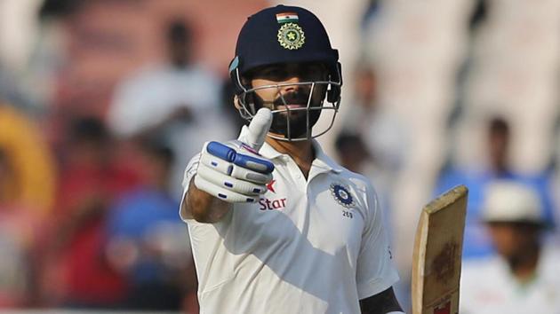 India captain Virat Kohli gestures towards his team's dressing room after scoring his hundred. (AP)